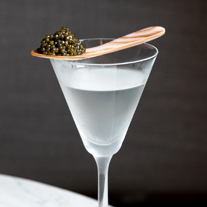 a glass with a spoon on top of it