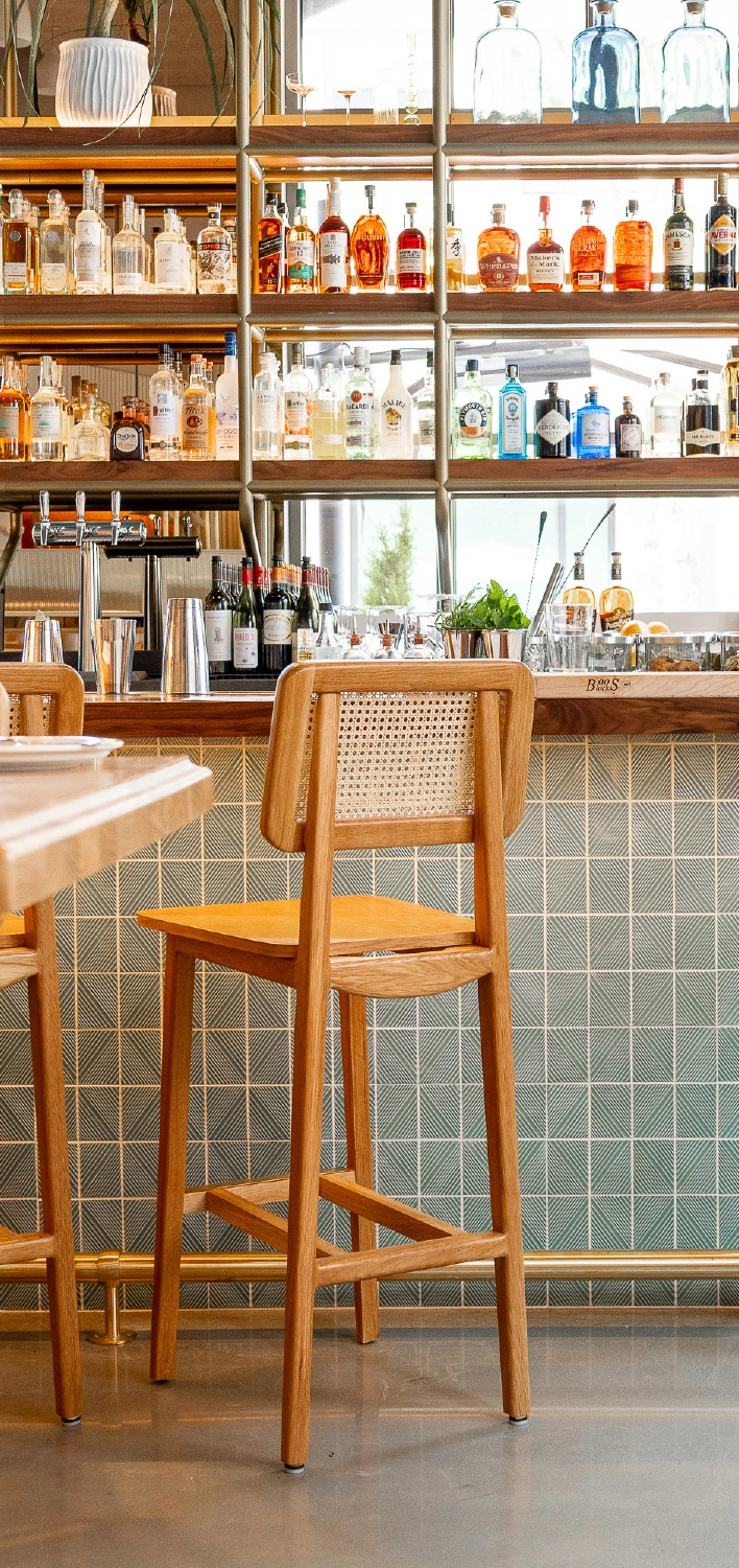 a wooden chair in front of a bar